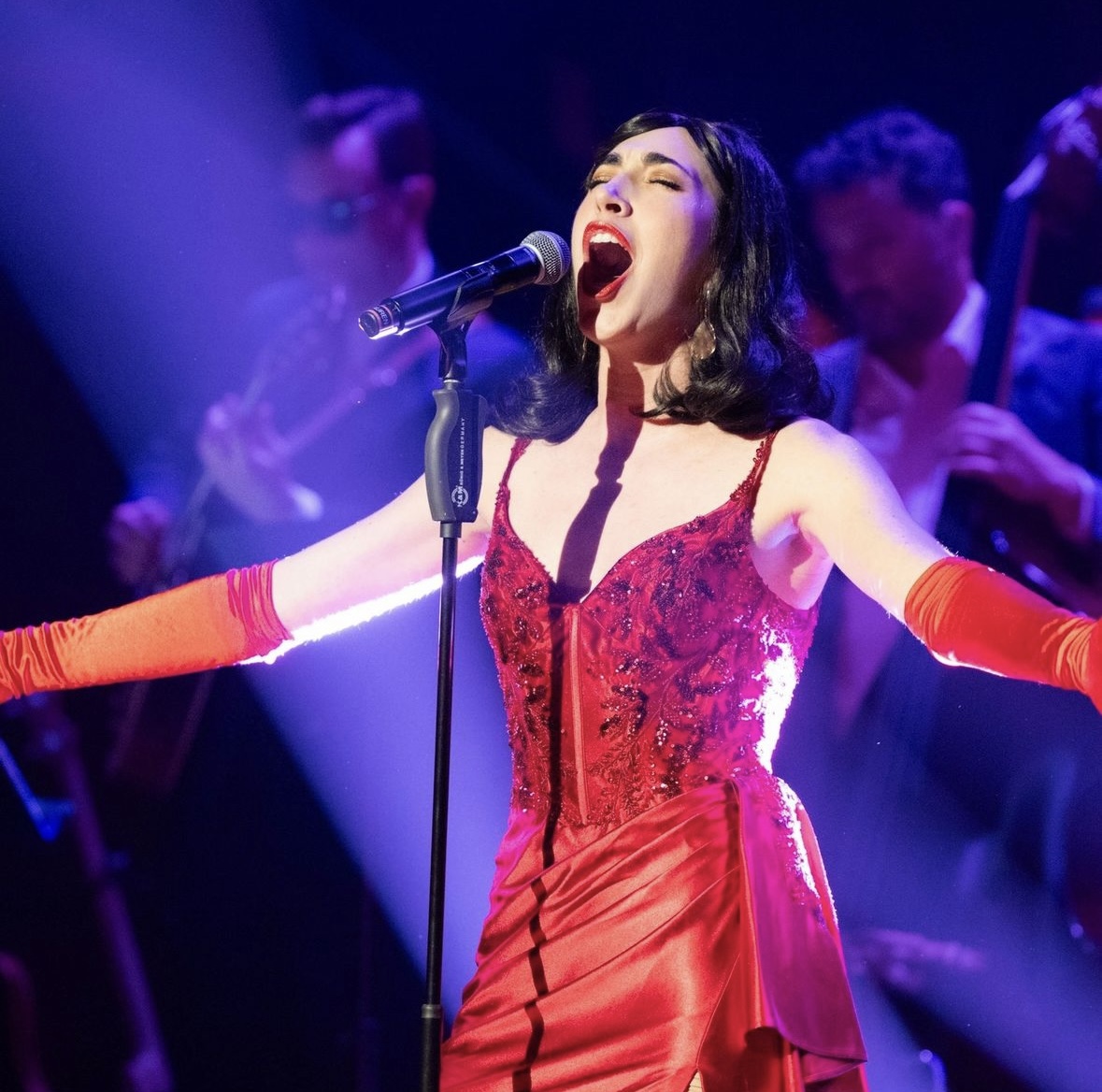 Lauren De Marco singing in red dress