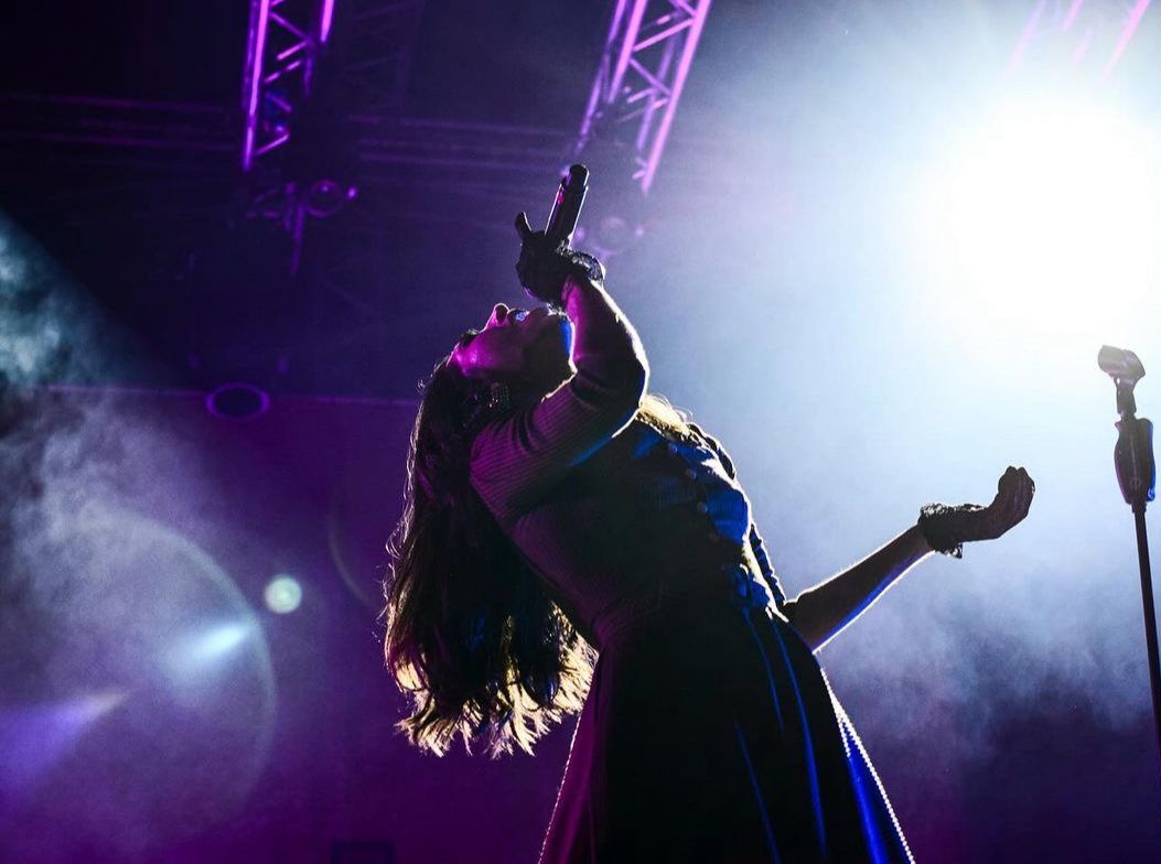 Lauren De Marco performing under stage lights