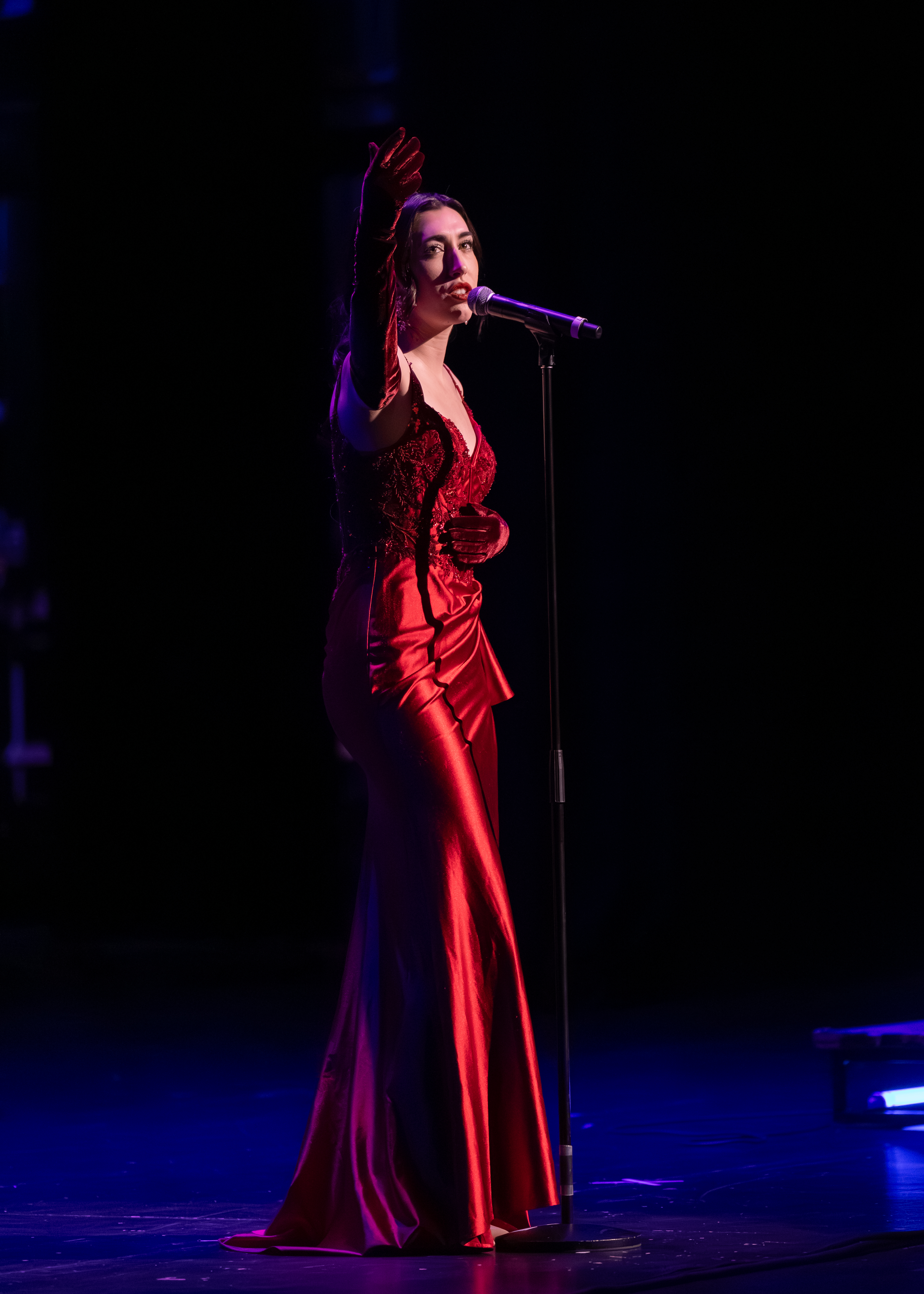 Lauren De Marco performing in red gown